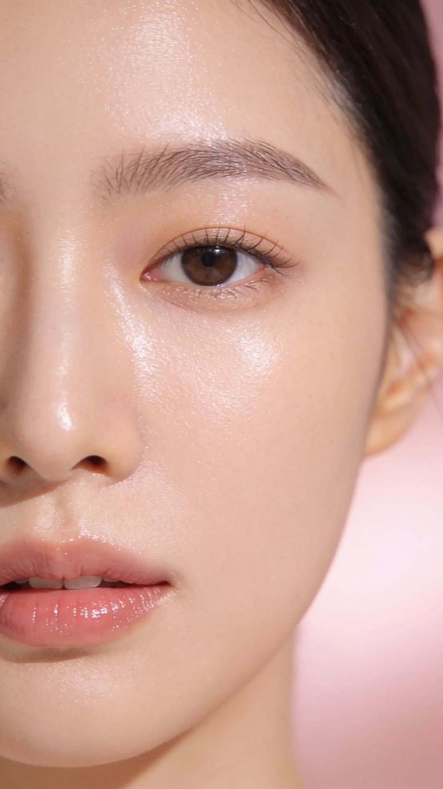 Close-up of a woman with naturally dry, flaky skin transforming into dewy, plump skin after a Korean skincare routine; show clear layers of lightweight products being applied: gel cleanser, essence, serum, cream, then sleeping mask; soft bathroom lighting with glass bottles, neutral tones, no text.